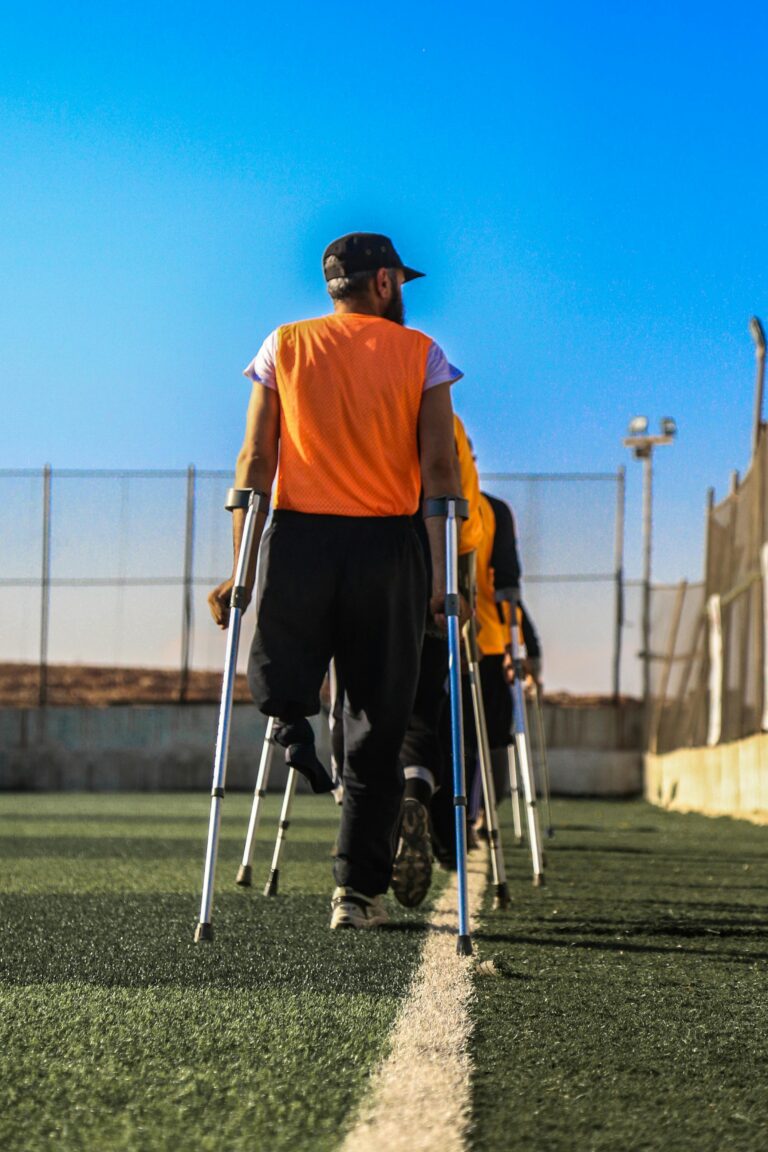 Adaptive sports team practicing outdoors on a sunny day.